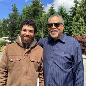 An older and younger African American man.